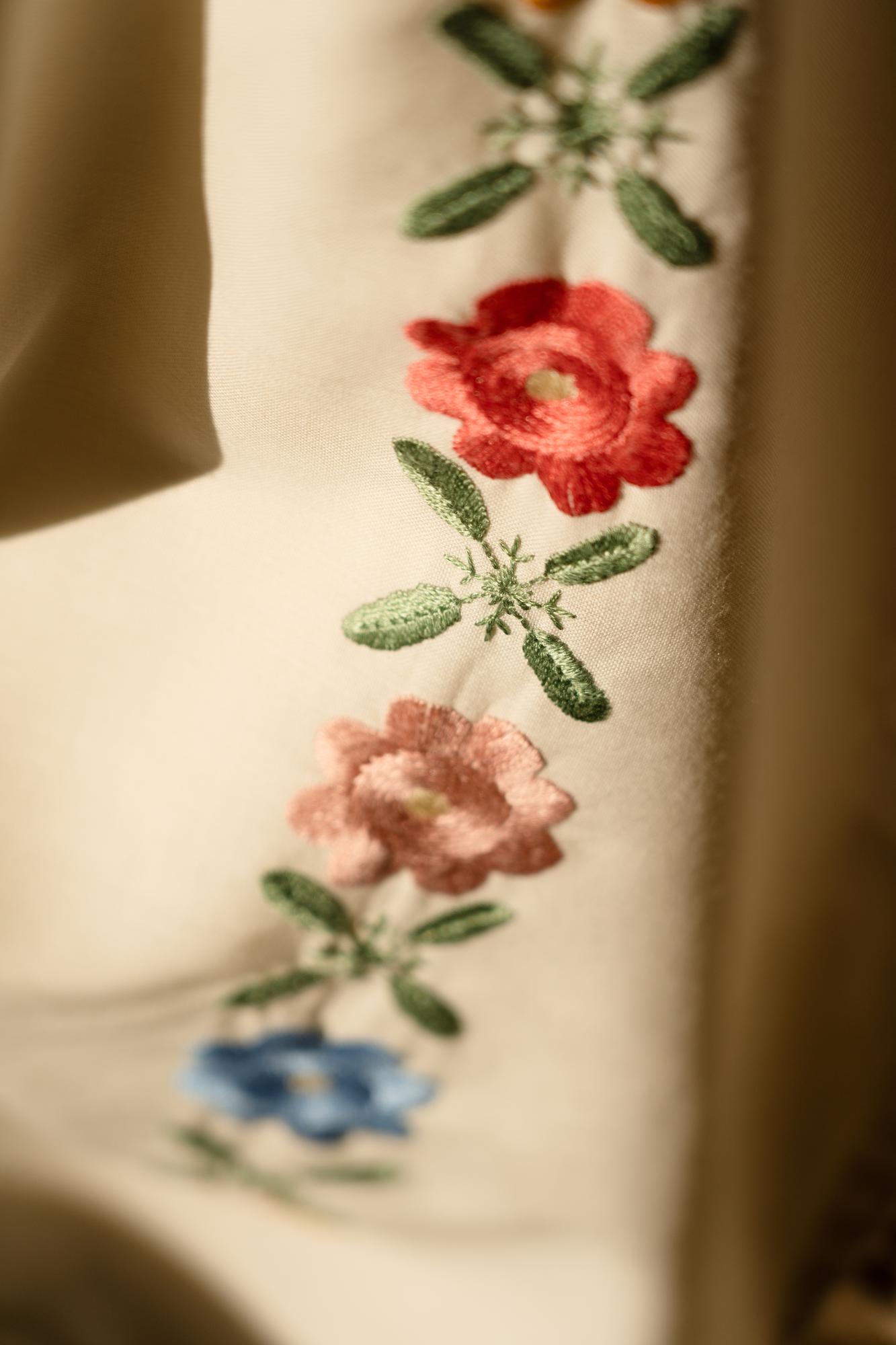 Close-up of floral embroidery on linen